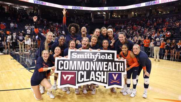The Virginia volleyball team celebrates after defeating Virginia Tech at John Paul Jones Arena.